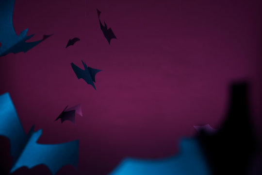 Halloween photo of blue bats on purple background.