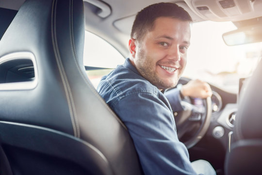 Photo of young man driving car