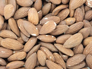 stack of almonds white background soft focus