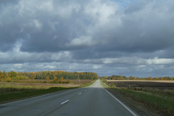 Fototapeta na wymiar Autumn scene with winding asphalt road in the countryside. 