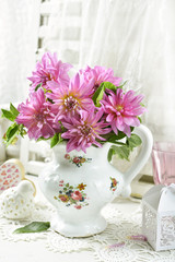 Obraz na płótnie Canvas bunch of pink dahlia in porcelain jug