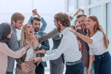 corporate group of employees congratulating each other on the victory