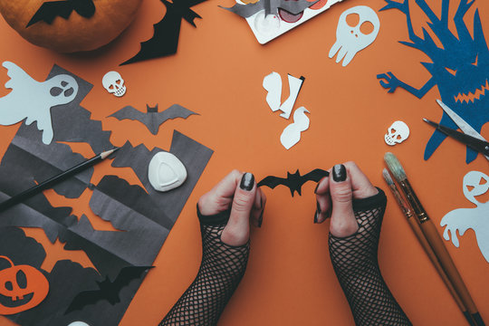 Image of halloween backgrounds with paper ghosts, pumpkin, skulls, human hands.