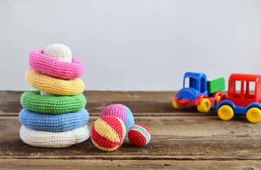 Crochet pyramid from colored rings. Toy for babies and toddlers to learn mechanical skills and colors. Handmade crafts. DIY concept.