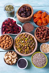 nuts, seeds and dried fruis on wooden surface