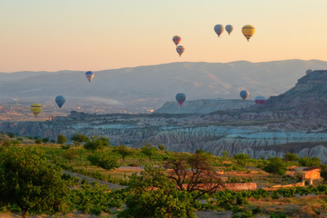 Interesting rocky terrain and a lot of airy multicolored balls in the air. Turkey. Cappadocia.