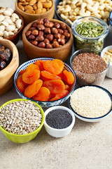 fresh nuts and dried fruis on granite surface