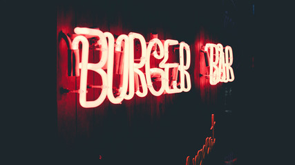 Red neon tube sign of burger bar