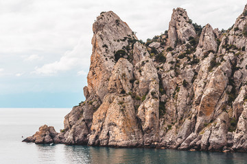 Landscape of sea with cliff and cloudy sky