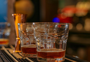 Glasses with alcoholic drink on a bar.