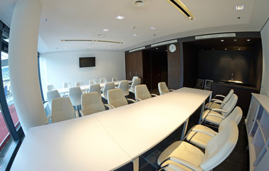 Empty conference room, tables, chairs, monitor - interior