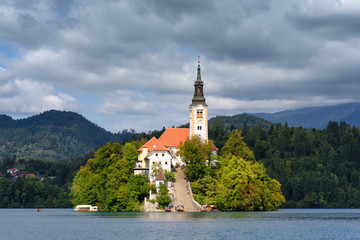 Bled Island with the church, recognizable symbol of the lake Bled (Blejsko jezero) in the Julian...