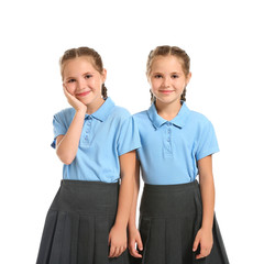Portrait of cute twin girls on white background