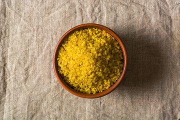 Bulgur on a dark background. wholesome organic food for breakfast or diet. Natural fabrics and...