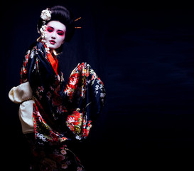 geisha in kimono on black