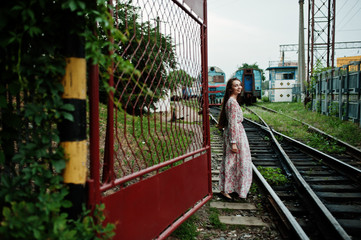 Lifestyle portrait of young girl posing on train station.