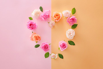Fototapeta na wymiar Heart shape made of beautiful rose flowers on color background