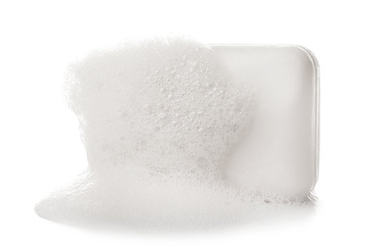 Soap bar with foam on white background