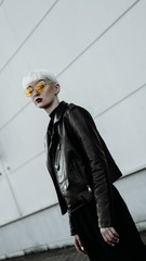 Portrait of woman with white hair and glasses. Modern urban style - vertical photo