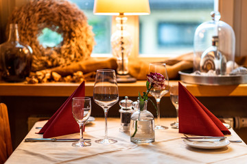 Wine glasses on a served table. A restaurant