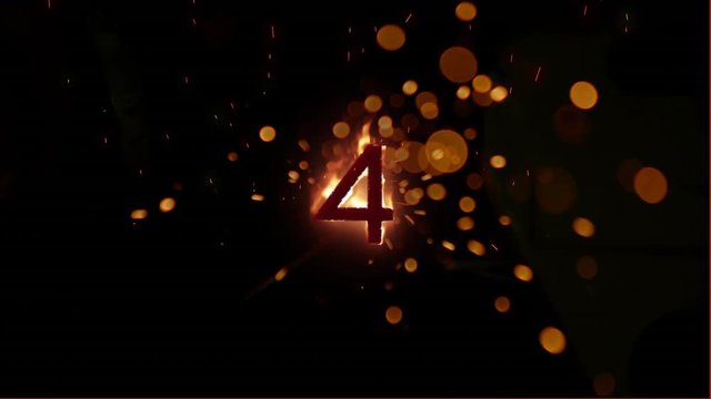 4 in flames on black background