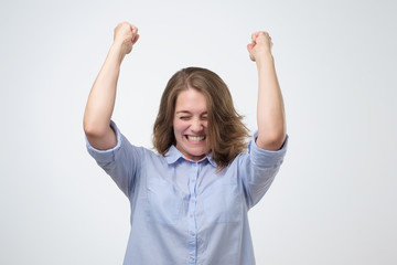 Happy caucasian girl with her fists up