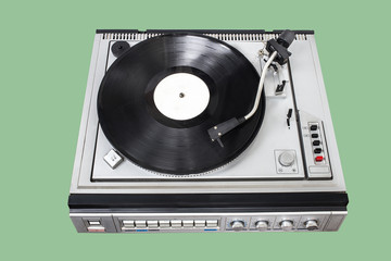 Obraz premium Vintage record player with radio tuner on green background