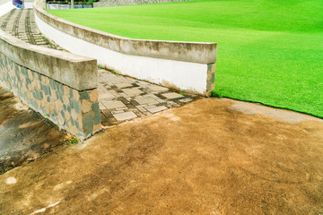 Ramp for wheelchairs in the park, Stone staircase in the garden, Stair ramp with green artificial turf in the park