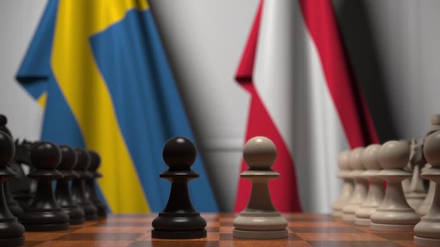 Flags of Sweden and Austria behind pawns on the chessboard. Chess game or political rivalry related 3D animation