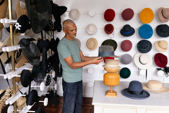 Man inspecting a hat in a hat store