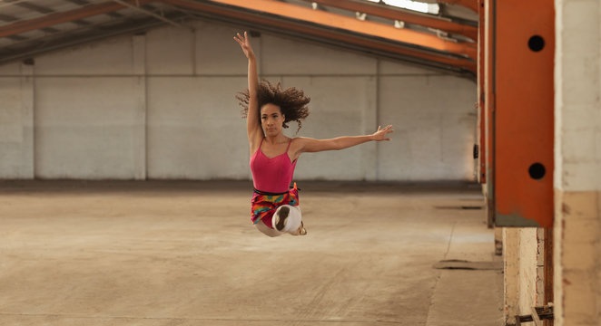 Female dancer in an empty warehouse