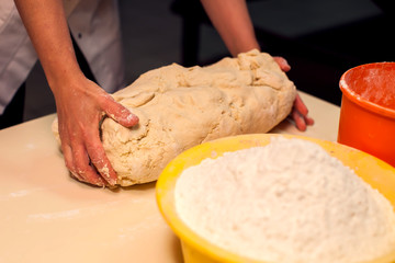 A dough with flour on the black background. Homemade food concept
