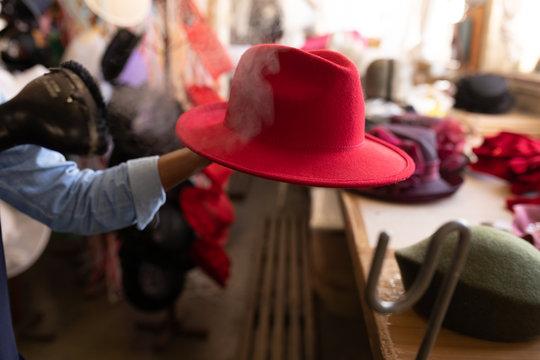 Red hat is steam finished in a hat factory