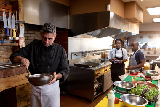 Chef working in busy restaurant kitchen