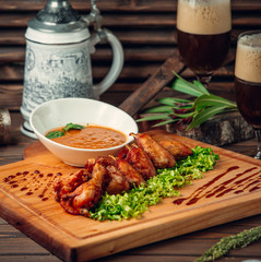 Chicken wings with sauce on the table