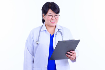 Happy overweight Asian woman doctor reading on clipboard