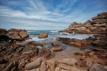 Fototapeta na wymiar Bretonic Coast and Beach with Granite Rocks at the Cote de Granit Rose - Pink Granite Coast