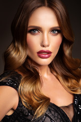 Beautiful model with curly hairstyle. Beautiful make up