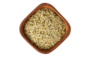 Organic shelled hemp seeds in wooden bowl  isolated on white background