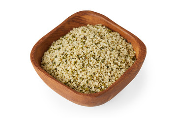 Organic shelled hemp seeds in wooden bowl  isolated on white background