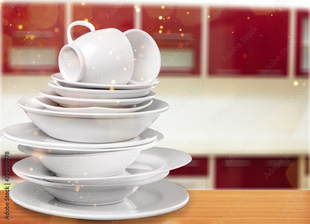 Wall mural pile of white dishware isolated on white