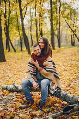 Couple in a park. Woman in a brown sweater. Man with a beard