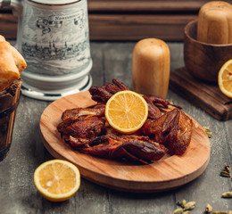 Fried chicken with lemon on the wooden board