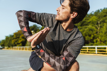 Fototapeta premium Photo of handsome concentrated man doing exercise