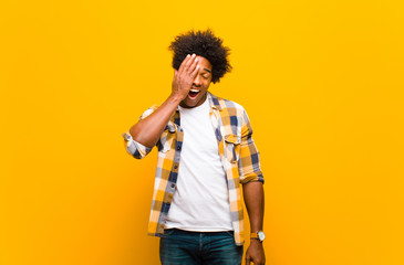young black man laughing and slapping forehead like saying d‚Äôoh! I forgot or that was a...