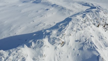 Sweden, drone flying sunny winter day around of the top of mountain in Northern Sweden. Breathtaking view over Scandinavian Mountains, Lappland.