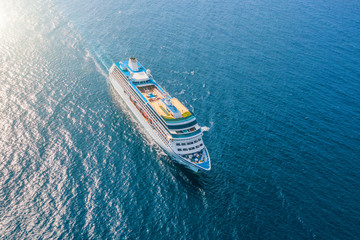 Cruise ship liner sails in the sea leaving a plume on the surface of the water seascape. Aerial view The concept of sea travel, cruises.