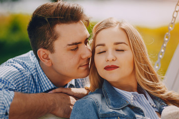 Fototapeta premium beautiful long-haired blonde with her handsome man holding hands on a small newborn son