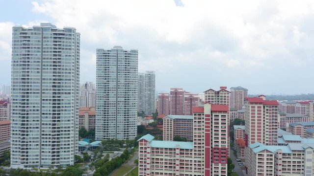 Aerial 4k footage of Public Housing Apartments of Singapore with Singapore skyline In Front Of A Nature Park In Singapore