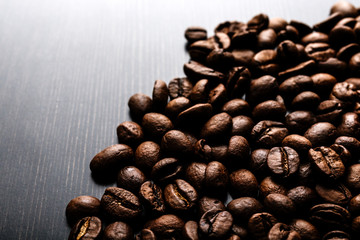 Coffee beans on wooden background.
